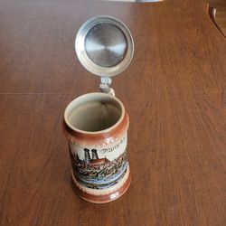Vintage German Beer Stein Porcelain Village River Lowenbrau Pewter Lid 
ZINN.

6 inches tall plus lid. Weight 1lb 10oz plus shipping materials.
Pre-ow