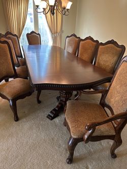 SOLID WOOD (11) PIECE DINETTE SET WHICH INCLUDES 2-LEAVES FOR EXTENSION 2-ARM CHAIRS & 8- REGULAR CHAIRS DAMASK FABRIC COVER CHAIRS(THE TABLE TOP HAS