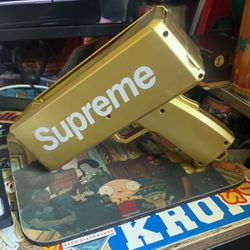 “supreme” Money Gun And A Stack Of Motion Picture Money