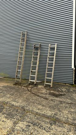 Three Older Aluminum Extension Ladders