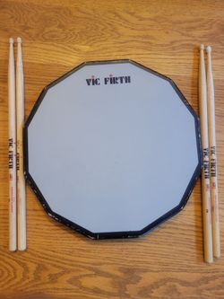 DRUM PAD: VIC FIRTH DOUBLE-SIDED. STICKS AND HOW-TO BOOK. In Mill Creek.