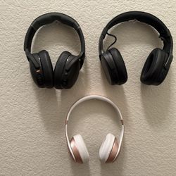 Three Overhead Earphones. 2 Skull Candy Crusher Evo & One BeatsSolo Wireless 