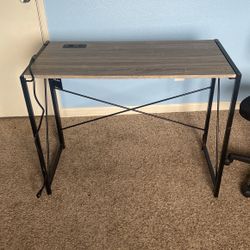 Grey Desk With Two Outlets And Black Chair 