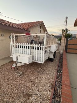White Utility Landscaping Trailer with solid walls and tall Mesh Sides