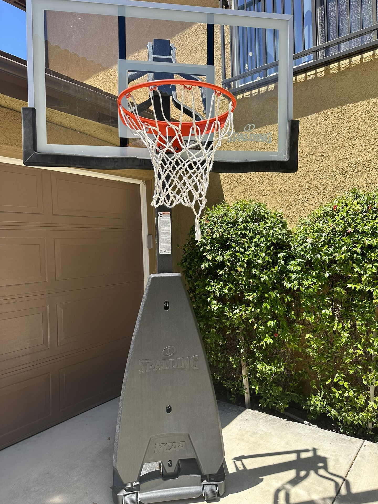 6-month old Spalding ULTIMATE HYBRID® 54" GLASS PORTABLE BASKETBALL HOOP.