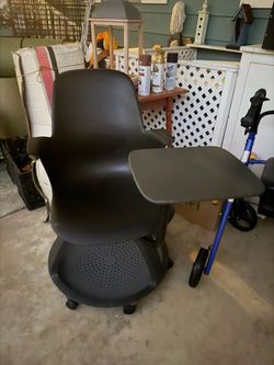 Unusual and unique swivel chair with built-in tray