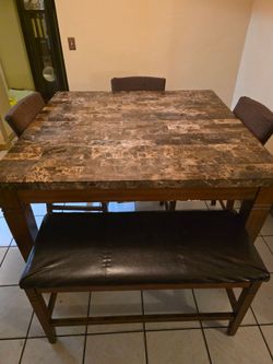 Dining room table with 3 chairs and bench