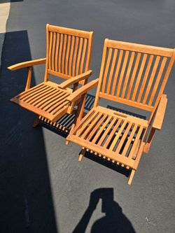Pair of folding teak patio chairs by Gloster,