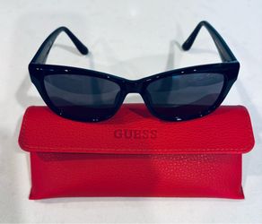 Guess women’s sunglasses and case.