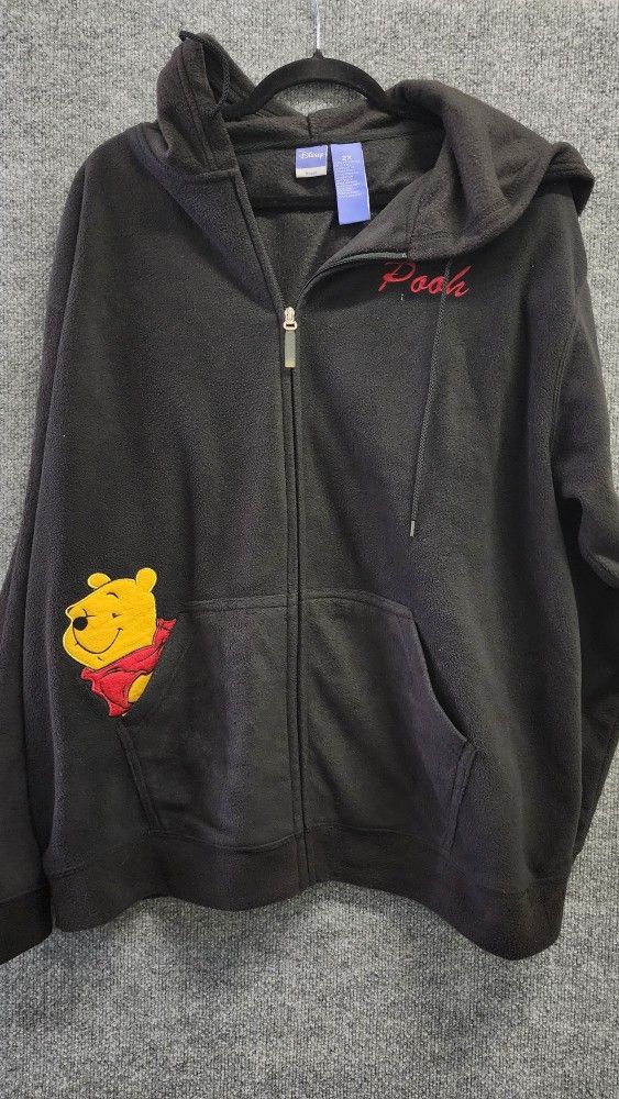 This is a black Disney Winnie the Pooh fleece zip-up hoodie. 