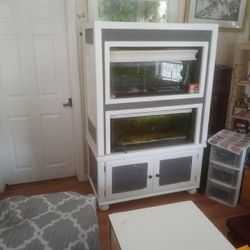 Homemade Fish Tank Stand Built To Last. Holes To 40 Gallon Tanks. And A Big Cabin On The Bottom.