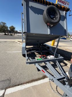 Gray Dump Trailer with Hydraulic Lift