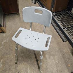 Shower chair with a backrest.