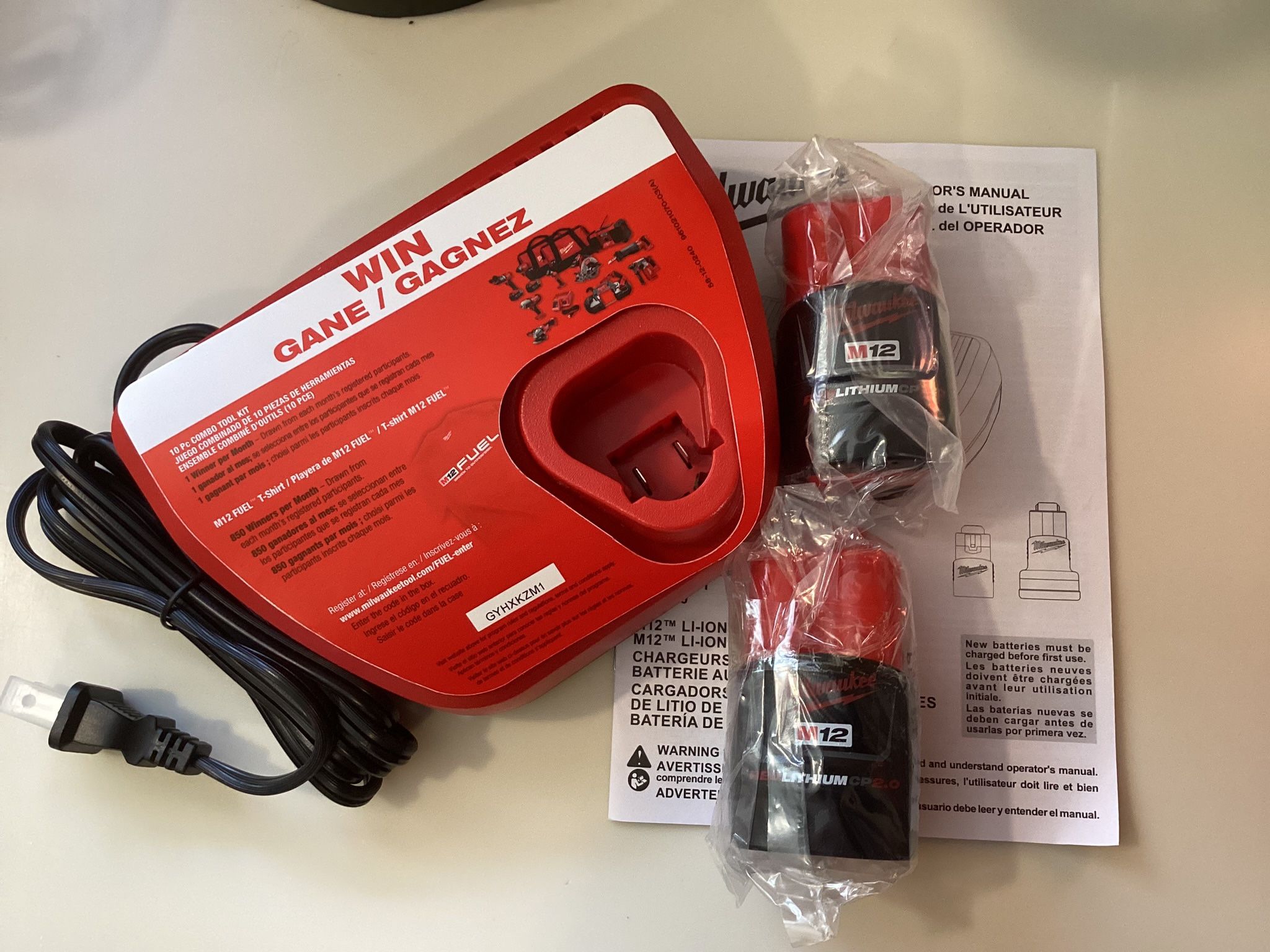 2 Milwaukee M12 12V Lithium-lon 2.0 Ah Batteries With M12 Charger. Brand NEW. NUEVO.
