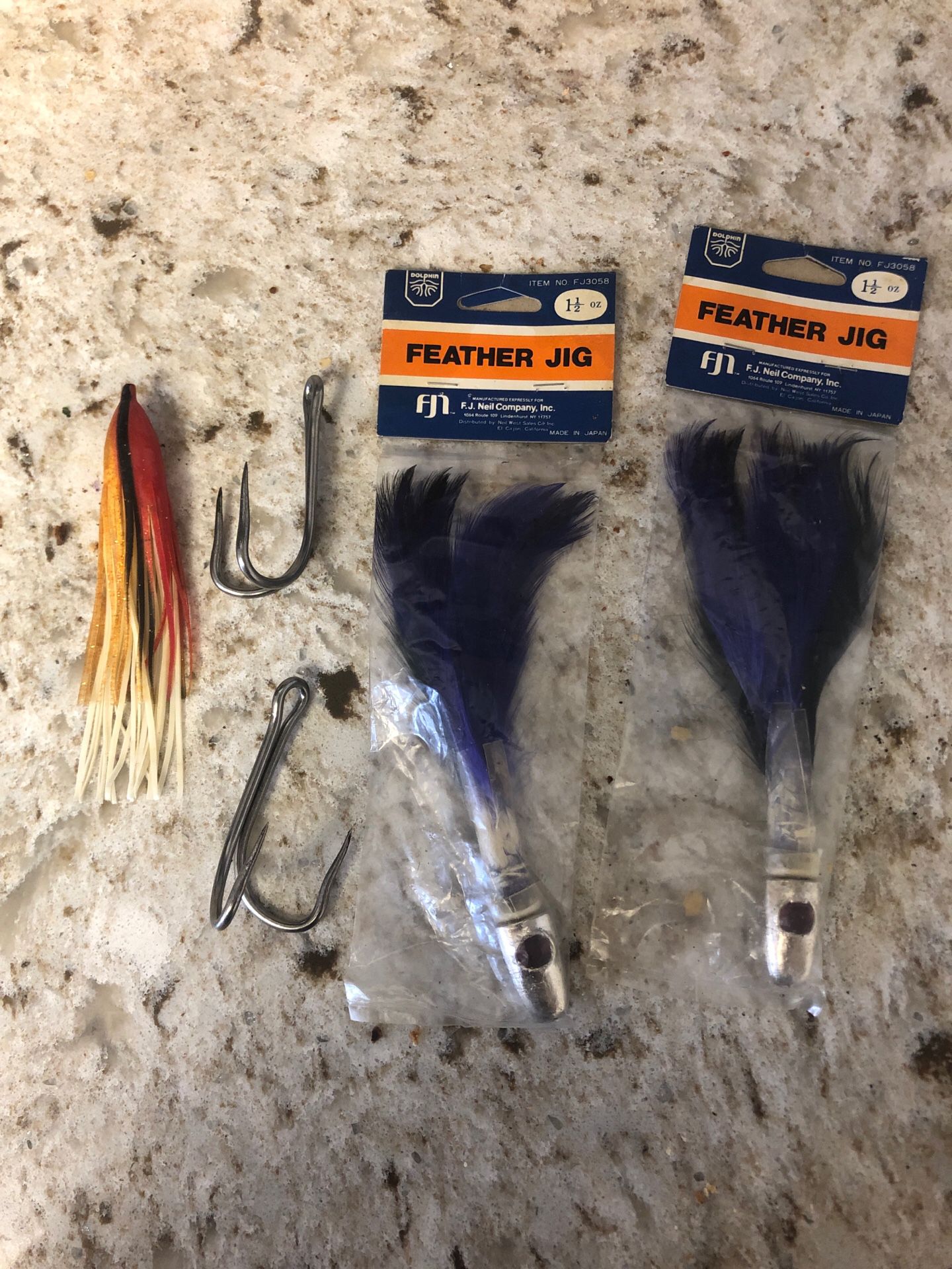 Lot of vintage fishing gear- 2 feather trolling jigs 1.5 oz and 2 double hook fang tuna hooks offshore fishing fj Neil company plastic dolphin