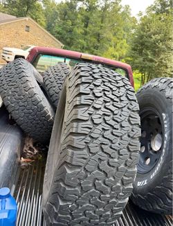 Almost full tread, ride amazing. Tires cost $1800 without the wheels cost around a thousand. 37/12.5r17 wheels are 8x6.5 bolt pattern.   All terrain a