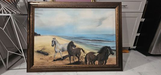 framed oil painting depicts three horses on a beach