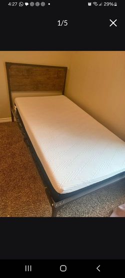 Twin-size bed frame with mattress in good condition.