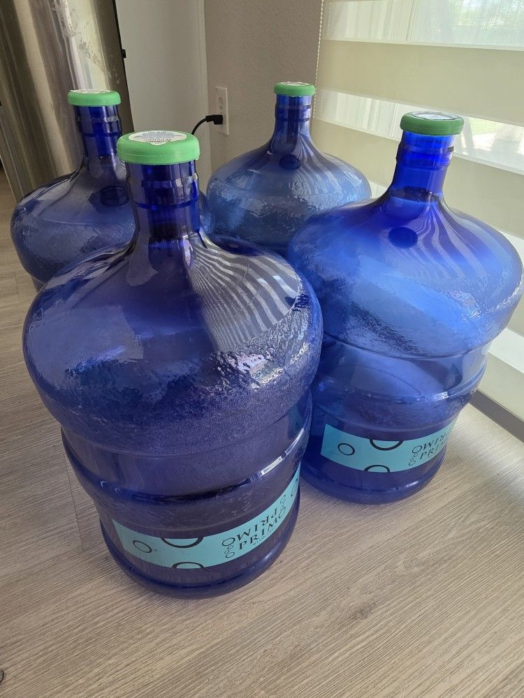 5 Gallon Primo Water Bottles with caps, 4 Bottles