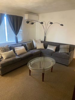 Living room set. Sectional (pillows included)coffee table, side table, spider lamp, lamp, and book case.