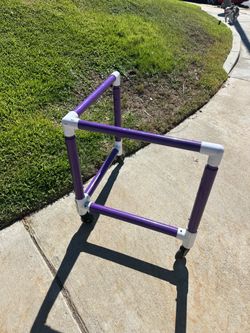 Purple Karben Sports SkateRanger SkaterAid is a roller skate trainer constructed from PVC pipe with wheeled casters.