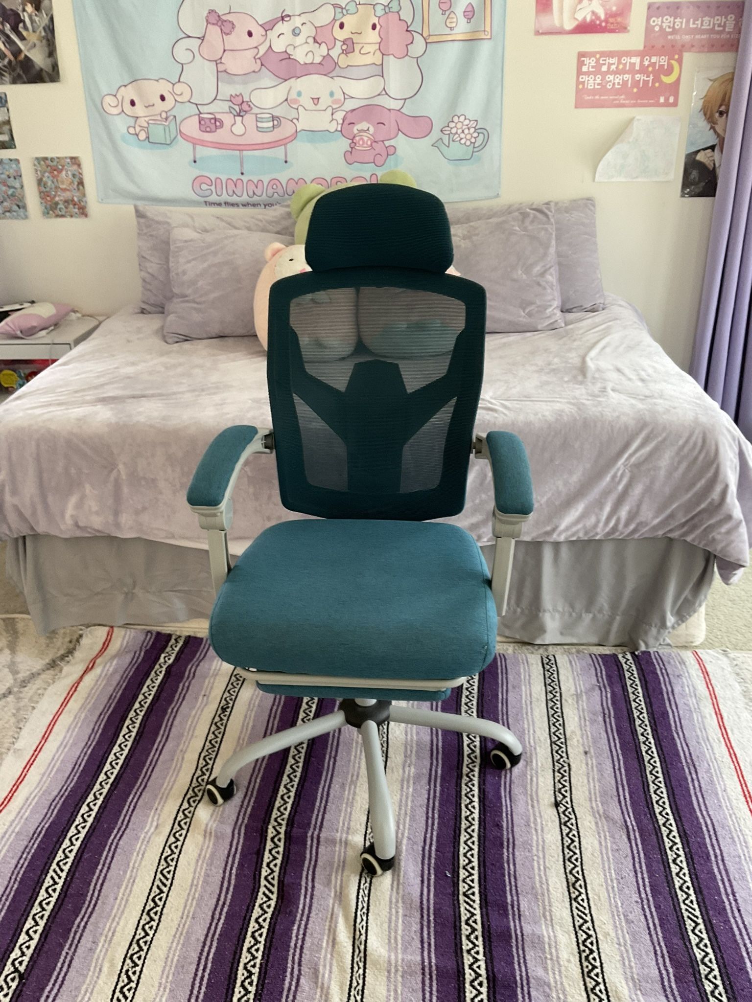 dark blue rolling chair with foot rest