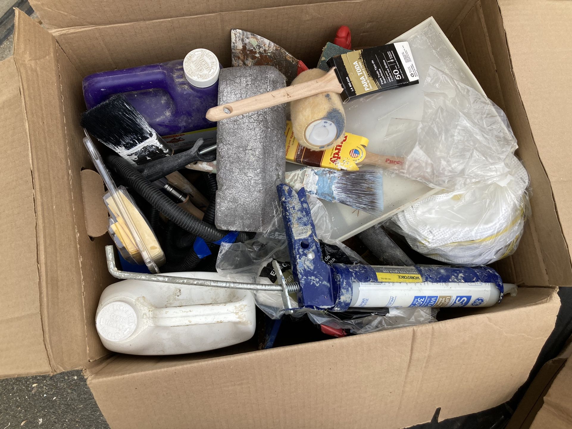 Box of assorted painting supplies and wallpaper removal