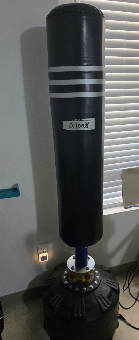 Standing Punching Bag With MMA Gloves.