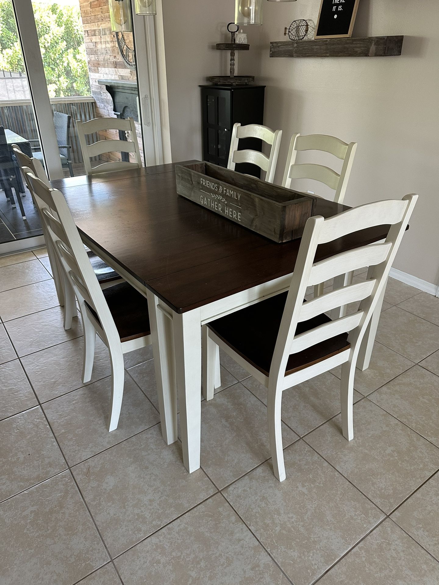 Large dining table with 8 chairs, a bench and a server