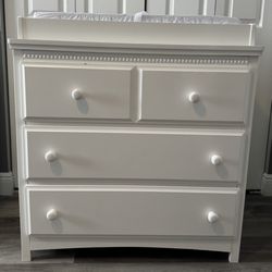 “Delta” Children 3 Drawer Dresser with Changing Top along with a “Colgate” Contour Changing Pad 