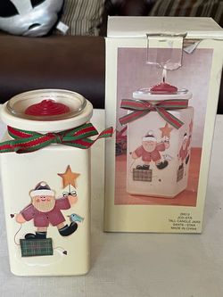Ceramic tall Christmas candle jar featuring a Santa and star motif 6.25” tall