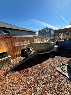 Wood and fiberglass drift boat with trailer