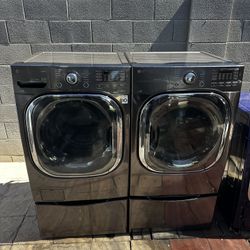 LG True Steam Front load washer and electric dryer on pedestals