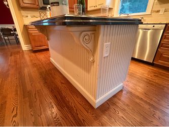 Cream kitchen island with black granite top