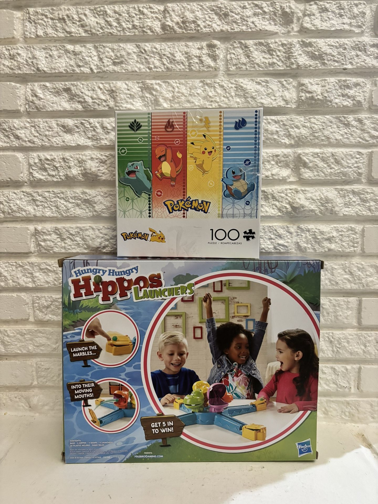 2 sets Buffalo Games 100-Piece Pokemon Sports Jigsaw Puzzle and HUNGRY HUNGRY HIPPOS LAUNCHERS Both sets in $25 with box