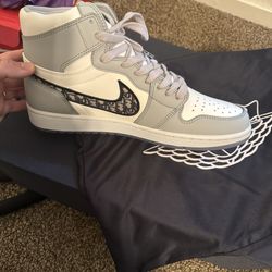 This product is the Nike Air Jordan 1 Retro High OG x Dior in the 'White Wolf Grey'