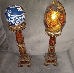 Set of glass eggs on stands