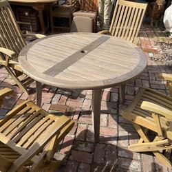 Vintage Smith And Hawken Teak Round Patio Table With 4 Folding Teak Chairs  Located in concord  Very good condition  Teak wood is heavy and sturdy  No