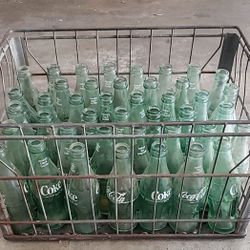 A crate of antique coke bottles