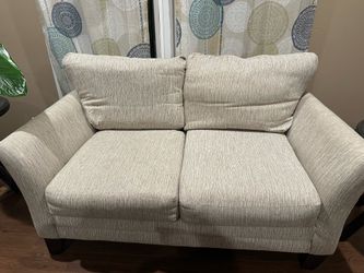 Beige Love Seat with Brown Legs