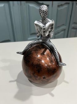 Book reading man on ball