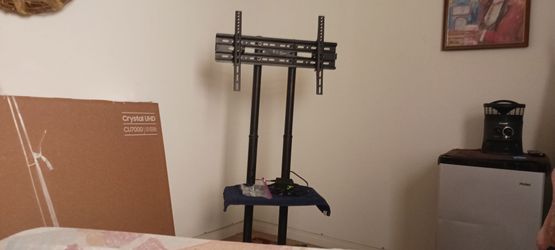 TV STAND ON ROLLING LEGS  HOLDS 65 TV