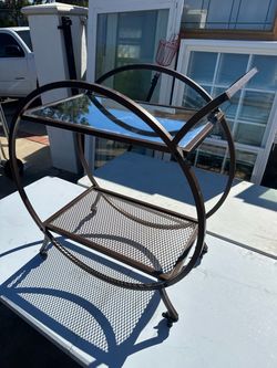 Small bar with glass and wheels that lock