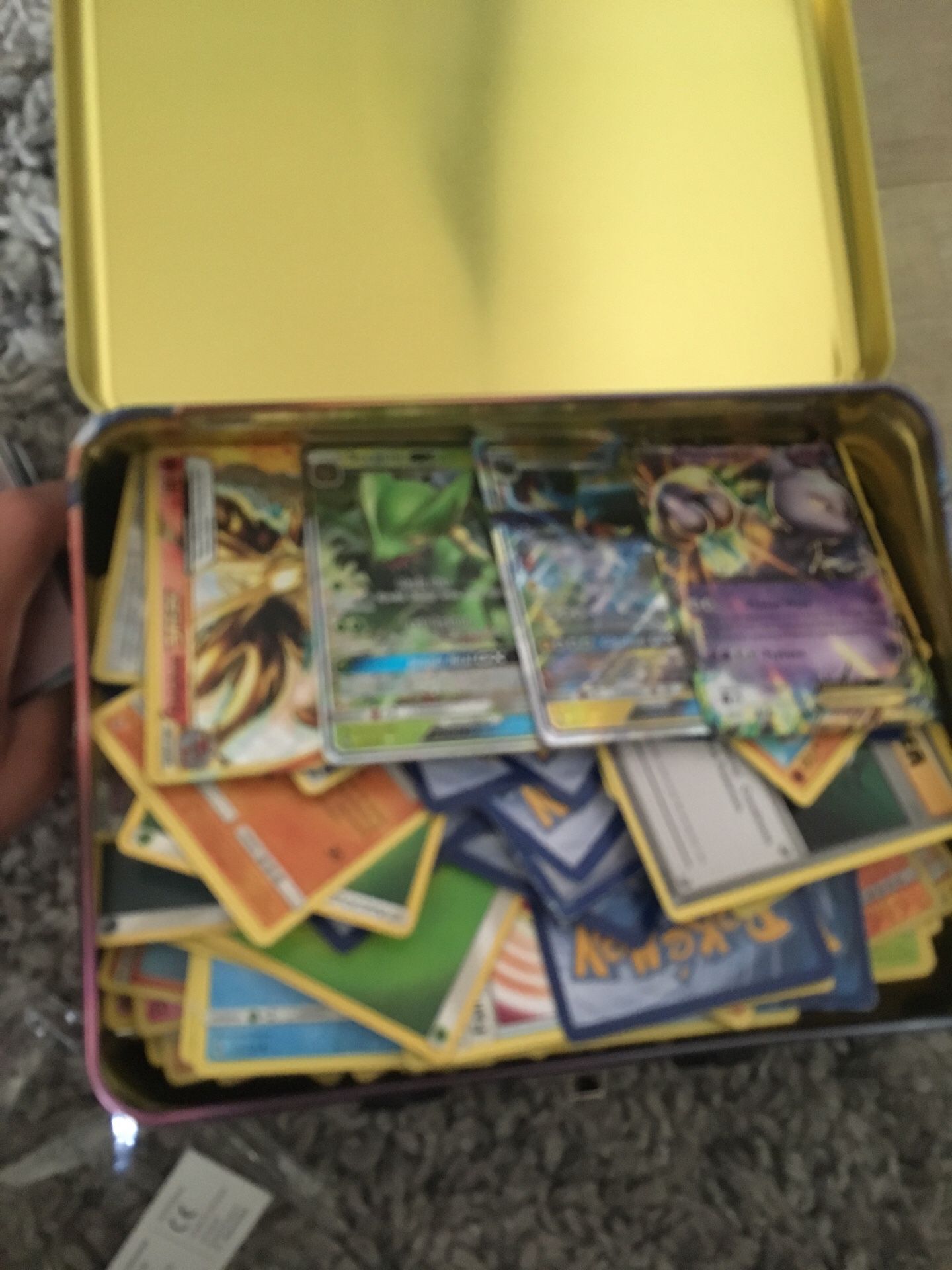 Pokemon sun and moon booster box and lunch pale filled with Pokémon cards