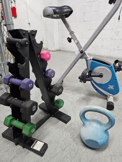 Folding Stationary Exercise Bike plus Fitness accessories.
Gray and blue folding stationary exercise bike with padded seat, handlebar grips, and peda