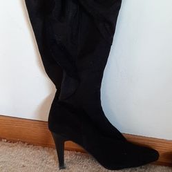 Pair of high heel, knee-high boots in black size 7
