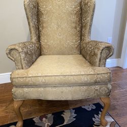 tan/gold wingback chair with felt floor protectors