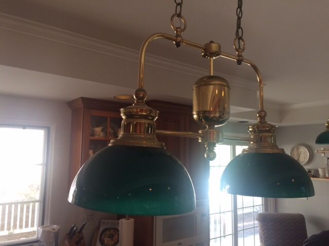 2 Brass and green glass light fixtures.