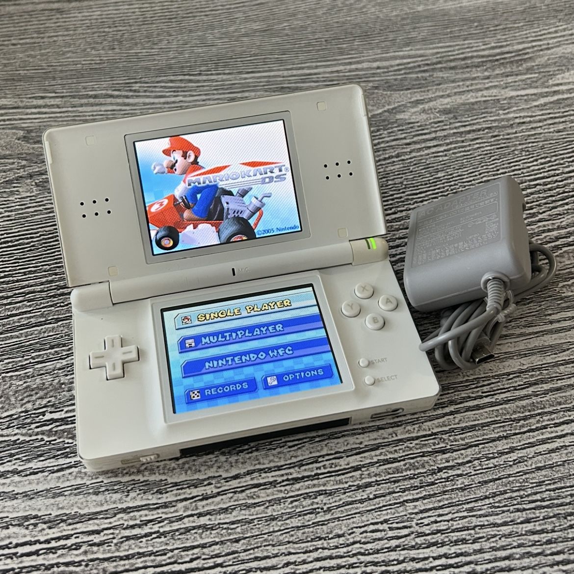 Nintendo DS with Mario Kart game, complete with stylus & charger. $55