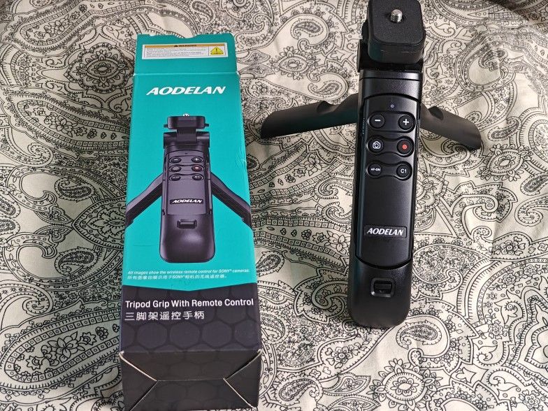 The AODELAN TG-1 is a wireless shooting grip tripod designed for Sony cameras, serving as a versatile accessory for vlogging, live streaming, and self